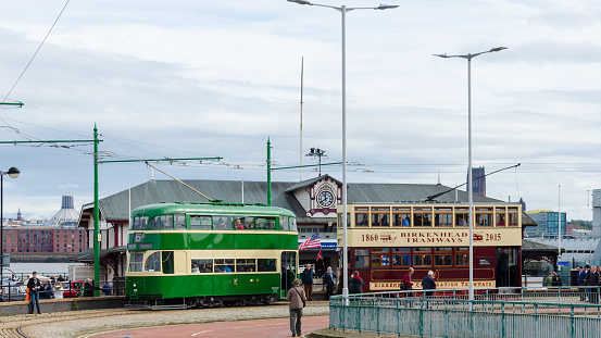 Birkenhead, UK: Oct 1, 2017: People enjoying 2 of the historic, restored trams which are operated on the Heritage Tramway by the Wirral Transport Museum. Seen here at the Woodside Ferry Terminal.