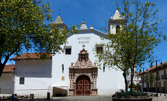 UNESCO world heritage site. Square of flower market and church Santuario Mariano del Carmen de la Asunción in historical center of city Cuenca, Ecuador