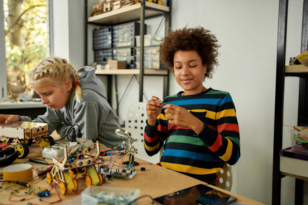 istock Knowledge is power. African american boy looking at detail while making toys at a technology class. Smart kids and STEM education. 1238424568