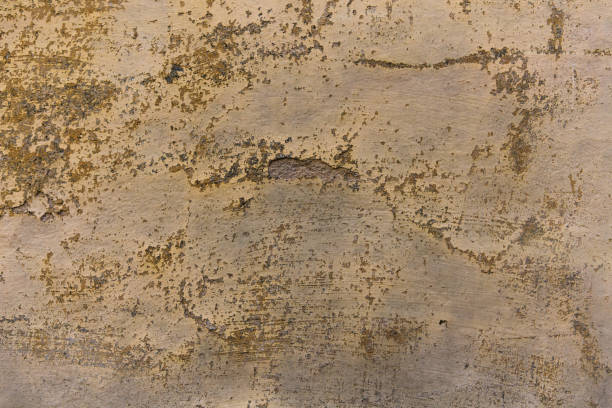 istock Old plastered wall with cracks. Ocher-colored ancient plastered wall of an antique building. Old stucco texture. Close up shot 1238471032