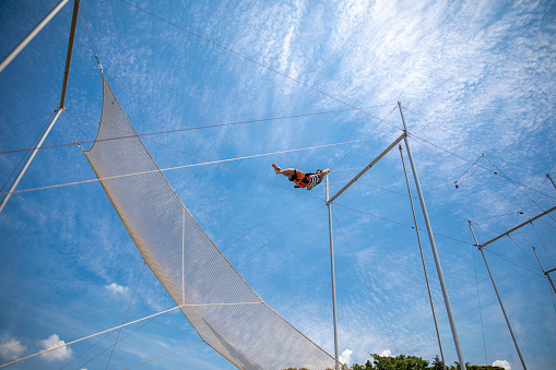 trapeze instructor swinging in the sky