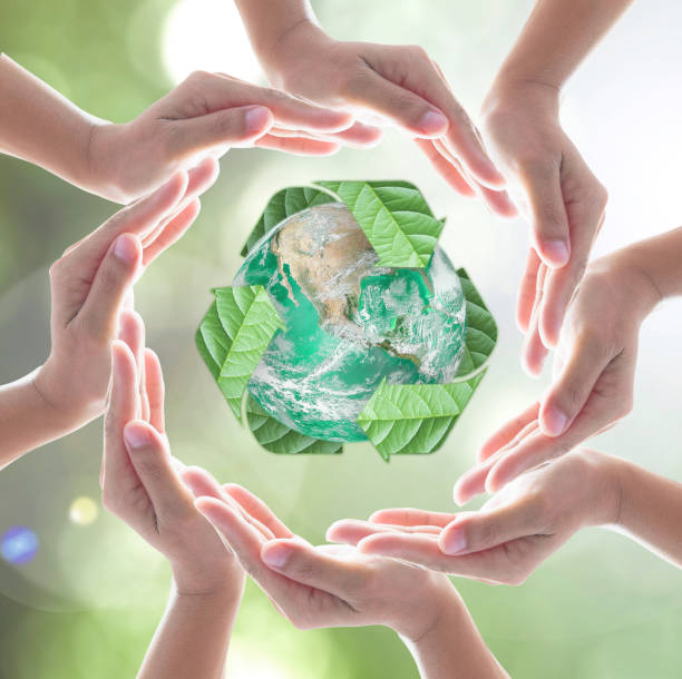 istock Hands surrounding green planet protected by recycle sign leaf on blurred bokeh .Elements of this image furnished by NASA 1238586597