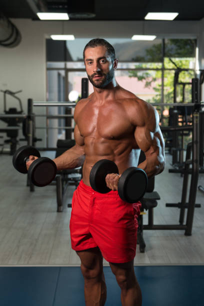 istock Healthy Man Exercising Biceps With Dumbbells 1238594574