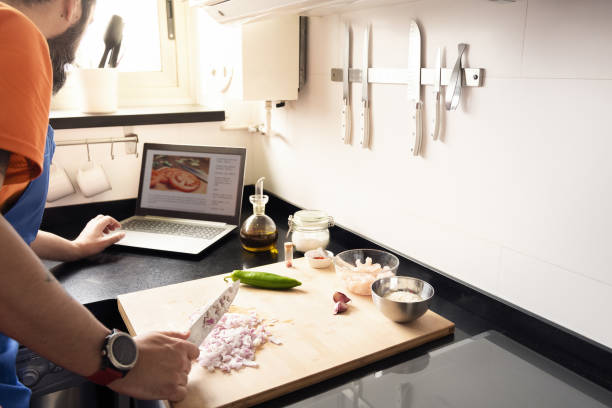 istock man consulting a recipe on the computer 1238595655