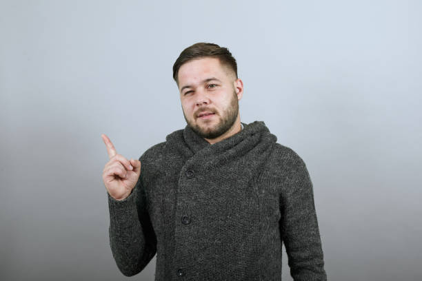 istock Focused Male Lifted Forefinger Up And Thinks. Smart People, Intellectuals 1238619487