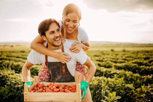 istock Couple having fun in strawberry filed 1238644000