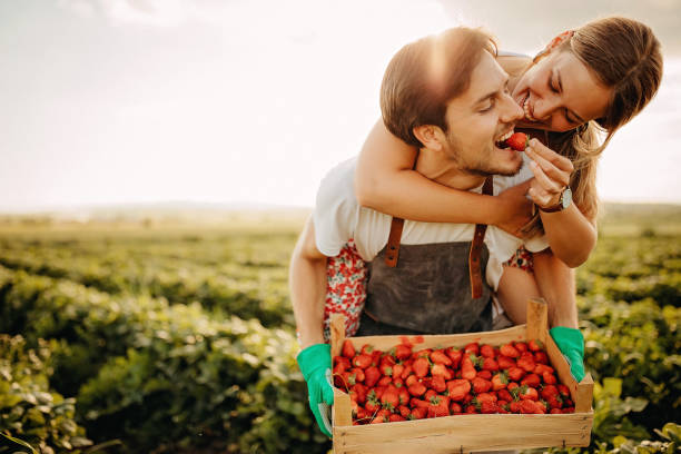 istock Couple having fun in strawberry filed 1238648616