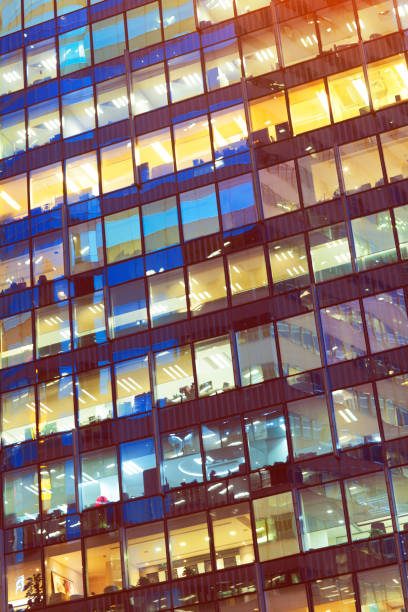 istock Illuminated office building skyscraper glass windows background in Hong Kong 1238695920