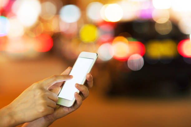 istock Close up view of hands holding mobile phone at night 1238707723