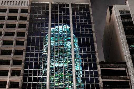 Window reflection of office business finance tower at night, Two International Finance Center building