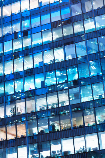 istock Tilted view office building skyscraper at night in Hong Kong 1238714579
