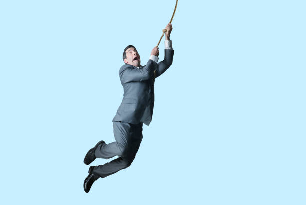 istock Businessman Swinging On Rope 1238754538
