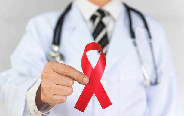 istock Doctor Holds Red Ribbon 1238858138