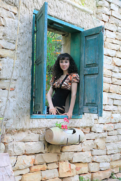 istock Woman sitting on window 123890543