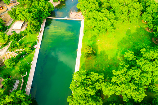 Bright Green Barton Springs landscape Aerial drone views above the green nature outdoors of Austin Texas USA