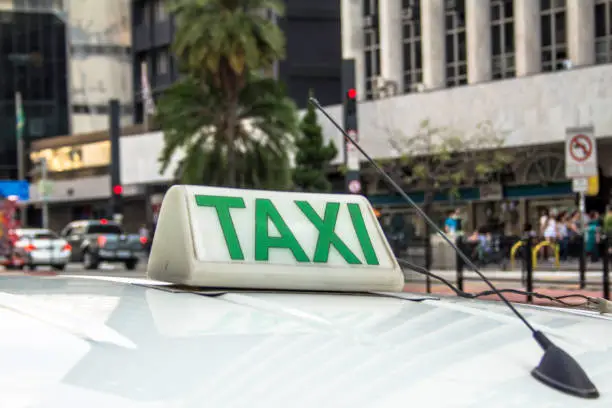 Photo of Taxi sign on roof of vehicle in Sao Paulo city