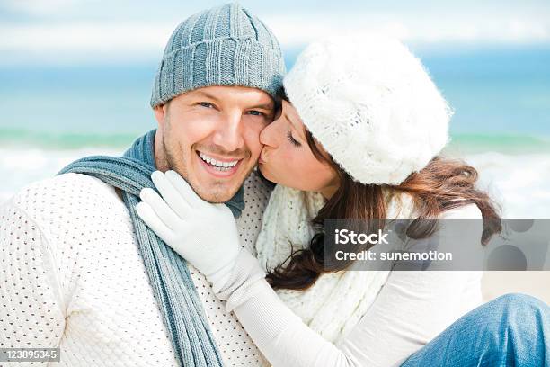 Joyful Couple Dressed In White And Blue Winter Apparel Stock Photo - Download Image Now