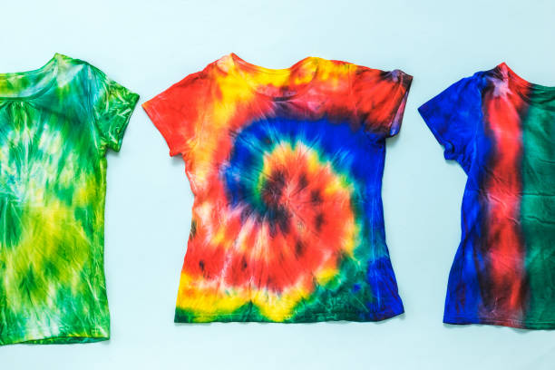 istock Three tie dye t-shirts on a light background. Flat lay. 1238985613