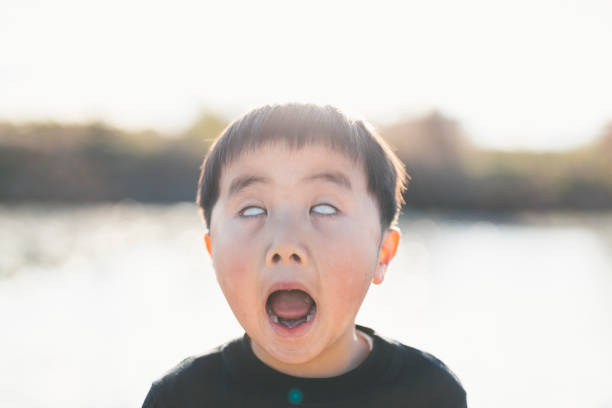 Portrait of a boy with his eyes rolled back