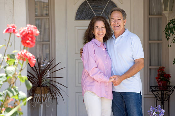 istock Couple Standing Outside Their House 123904312