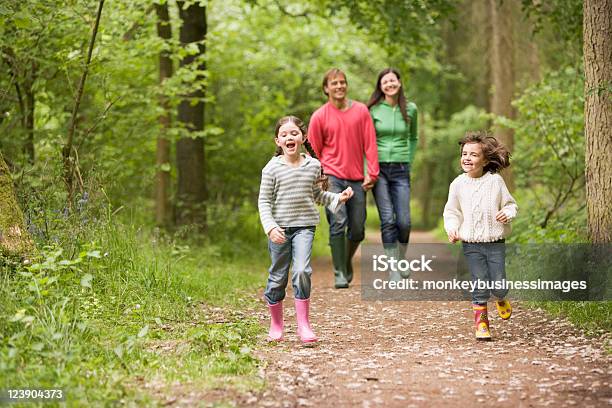 Happy Family Walking On A Path In The Woods Stock Photo - Download Image Now - Family, Walking, Forest