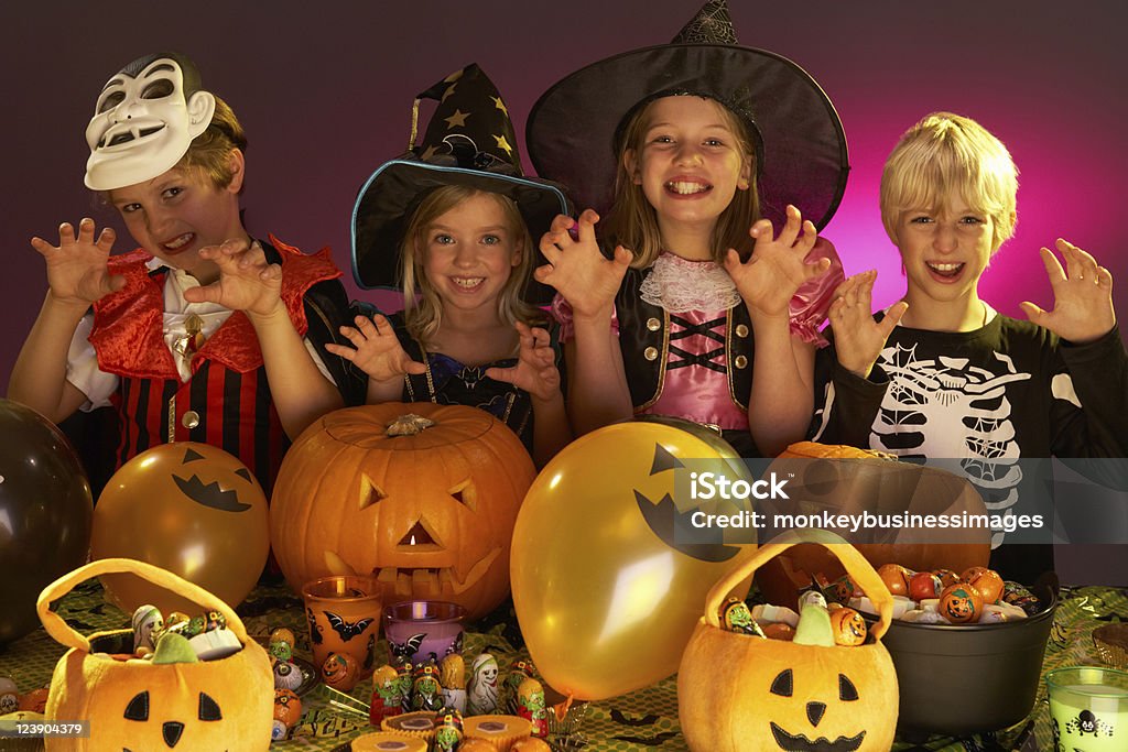 Halloween party with children wearing fancy dress costumes Halloween party with children having fun wearing fancy dress costumes  Child Stock Photo