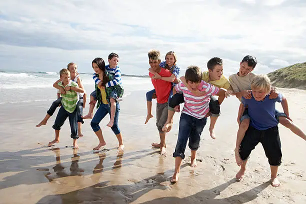 Photo of Teenagers playing piggyback