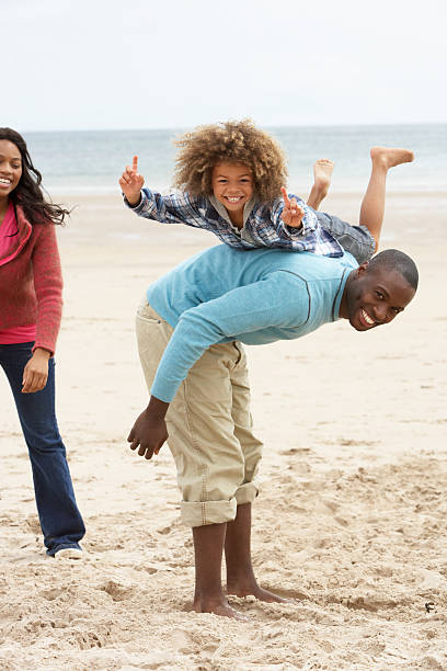 Young family (with kids) on a beachside. Black and white