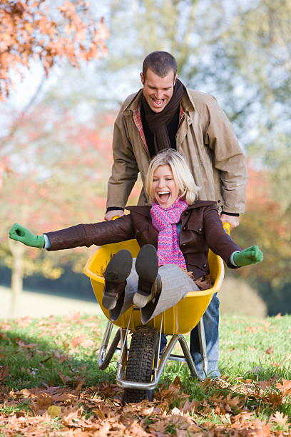 istock Man pushing wife in wheelbarrow 123905029