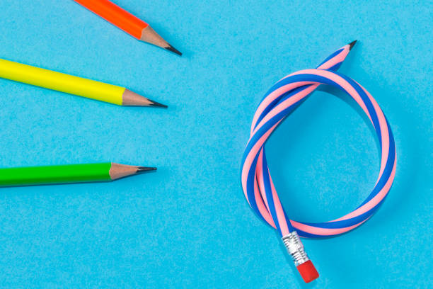 istock Simple pencils and flexible pencil on a blue background. Close up. Selective focus. 1239070931