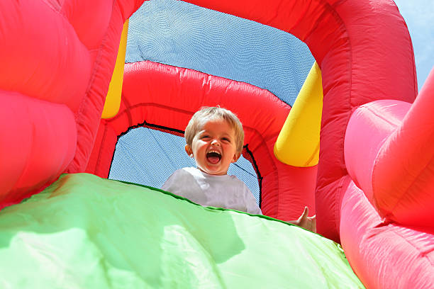 istock Child on bouncy castle slide 123908778