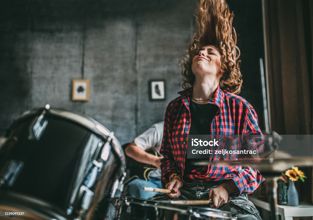 Teenager Playing Rock and Roll At Home Drum - Percussion Instrument Stock Photo