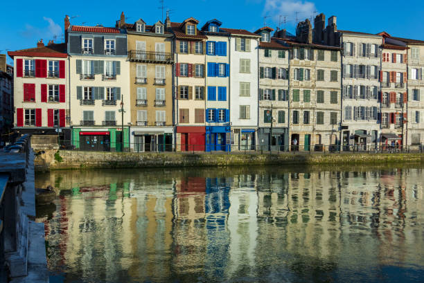 Old colorful houses of "Le Petit Bayonne" district along the river Nive, Bayonne, France Old colorful houses of "Le Petit Bayonne" district along the river Nive. Nice reflections of the buildings in the water. Bayonne, France bayonne stock pictures, royalty-free photos & images
