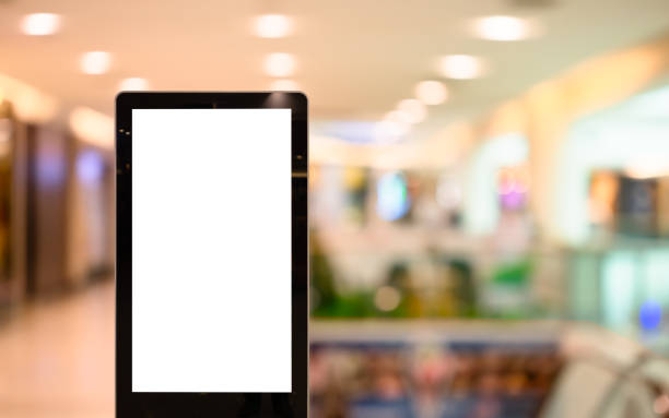 istock Mockup blank white screen advertising board or  showcase billboard in modern department store. Mock up billboard for your text message or media content with blur department store or shopping mall 1239094491