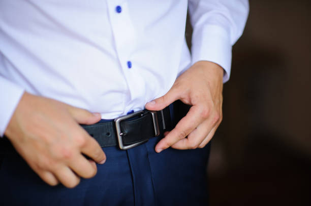 istock groom dressing up in the room 1239095637