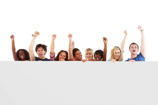 istock Diverse Teens Celebrating Behind a Blank Sign - Isolated 123909677
