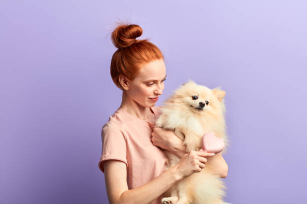 istock pleasant smiling girl enjoying rushing her pet 1239131701