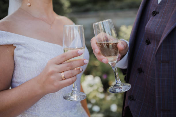 istock glasses with champagne in the hands at wedding 1239132263