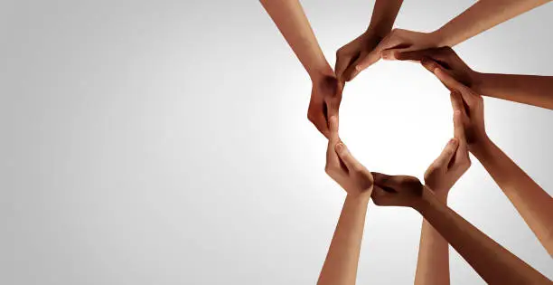 Business Unity and diversity partnership as hands in a group of diverse people connected together shaped as a support circle symbol of group team or teamwork and togetherness.