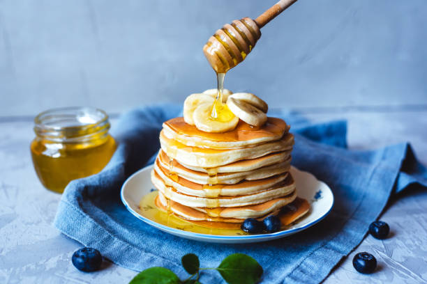 istock Stack of pancakes with fresh banana. 1239140382