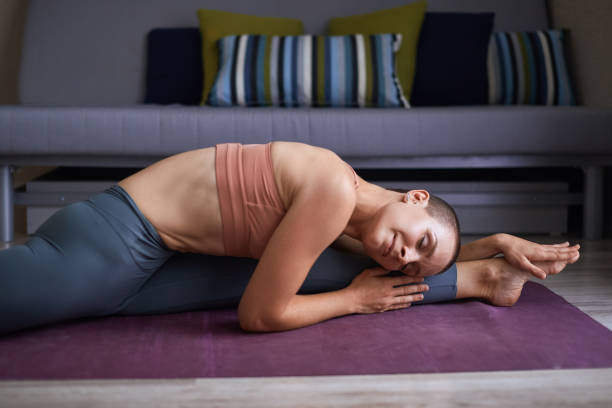istock Beautiful sporty woman doing stretching exercise in yoga split 1239153326