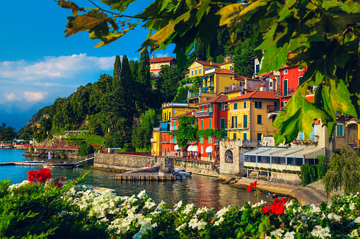 Flowery garden on the lake shore and beautiful view with colorful buildings, lake Como, Varenna, Italy, Europe