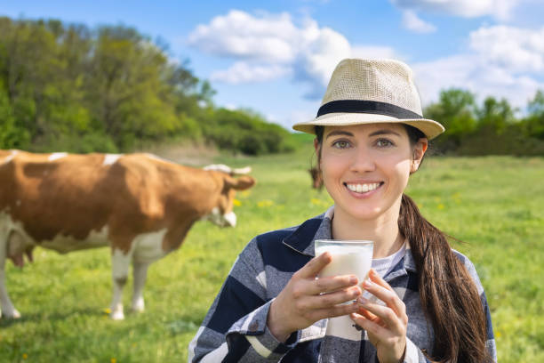 istock young woman drinking milk outdoors 1239178038