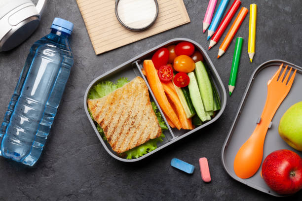 istock School lunch box and education stationery on stone table 1239184970