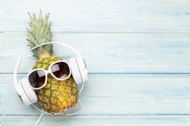 istock Ripe pineapple with sunglasses and headphones 1239191424
