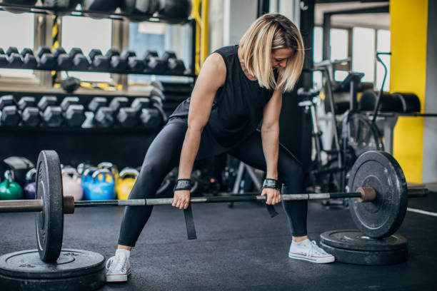 istock Young woman weightlifting 1239213095