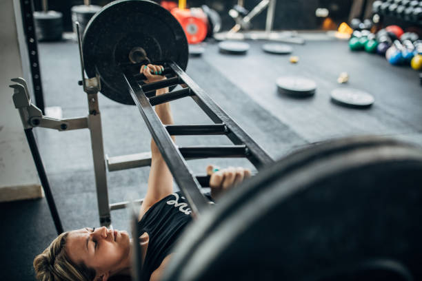 istock Sporty woman weightlifting 1239218964