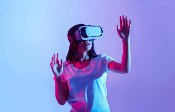 istock Modern device. Surprised asian girl in virtual glasses 1239221047