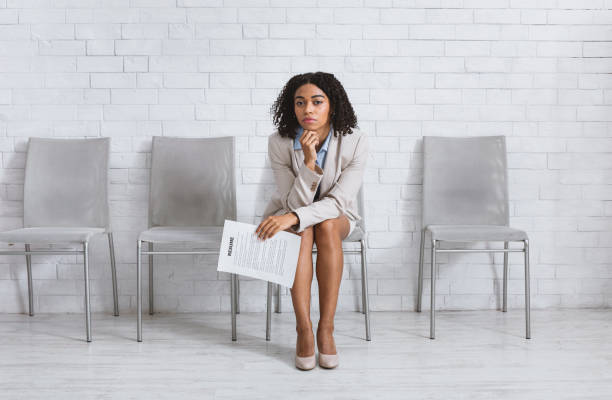 istock Weary young lady with CV waiting for screening interview at office lobby. Copy space 1239222080