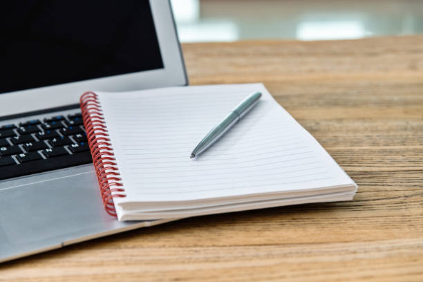 istock Laptop with pen and notepad on the desk 1239226310